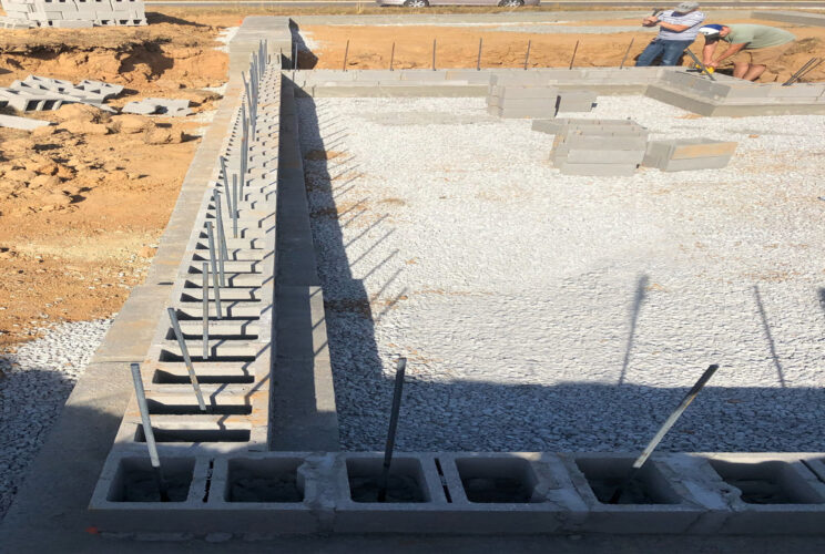 A house foundation is the structural base upon which a residential building rests. It plays a crucial role in distributing the weight of the house evenly to the underlying soil, ensuring stability, and preventing settlement or structural damage.